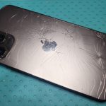 An iPhone with damaged rear glass
